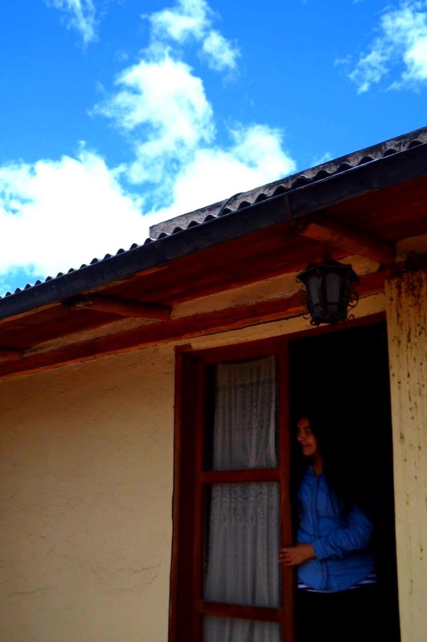 Mariel Cárdenas asomada a la ventana del hostel en Quito, Ecuador
